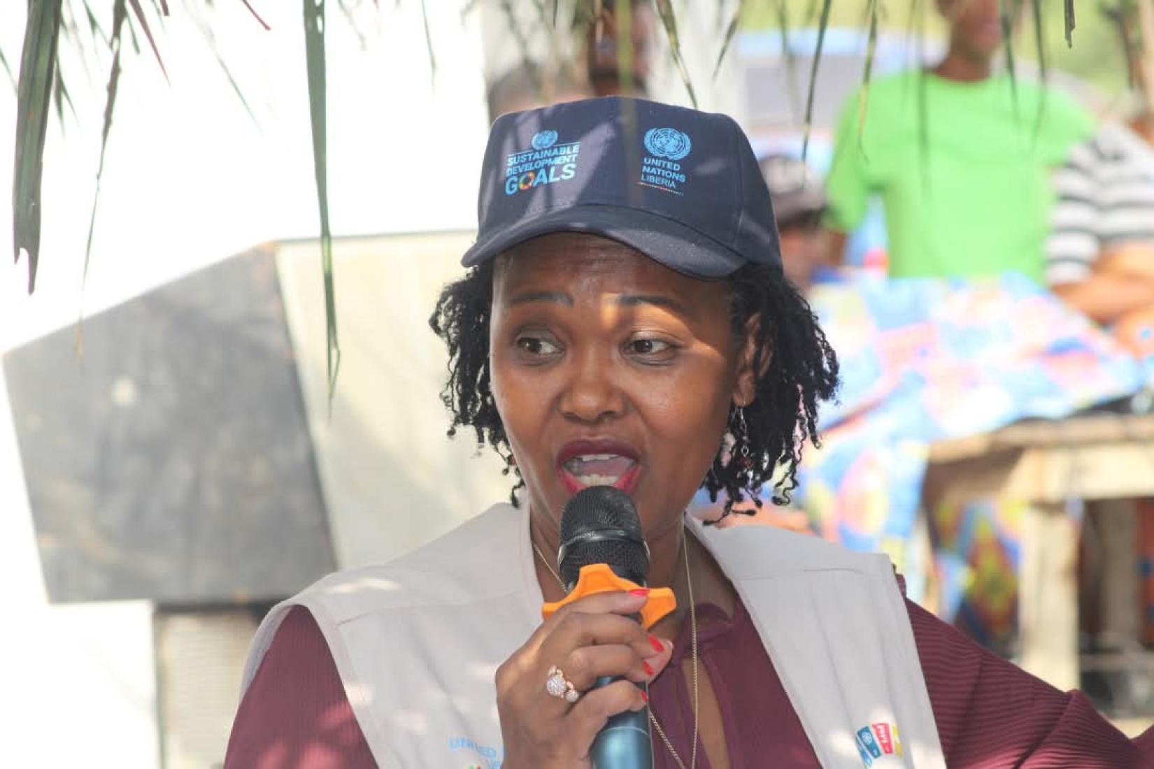 A woman wearing a hat and looking at the camera 