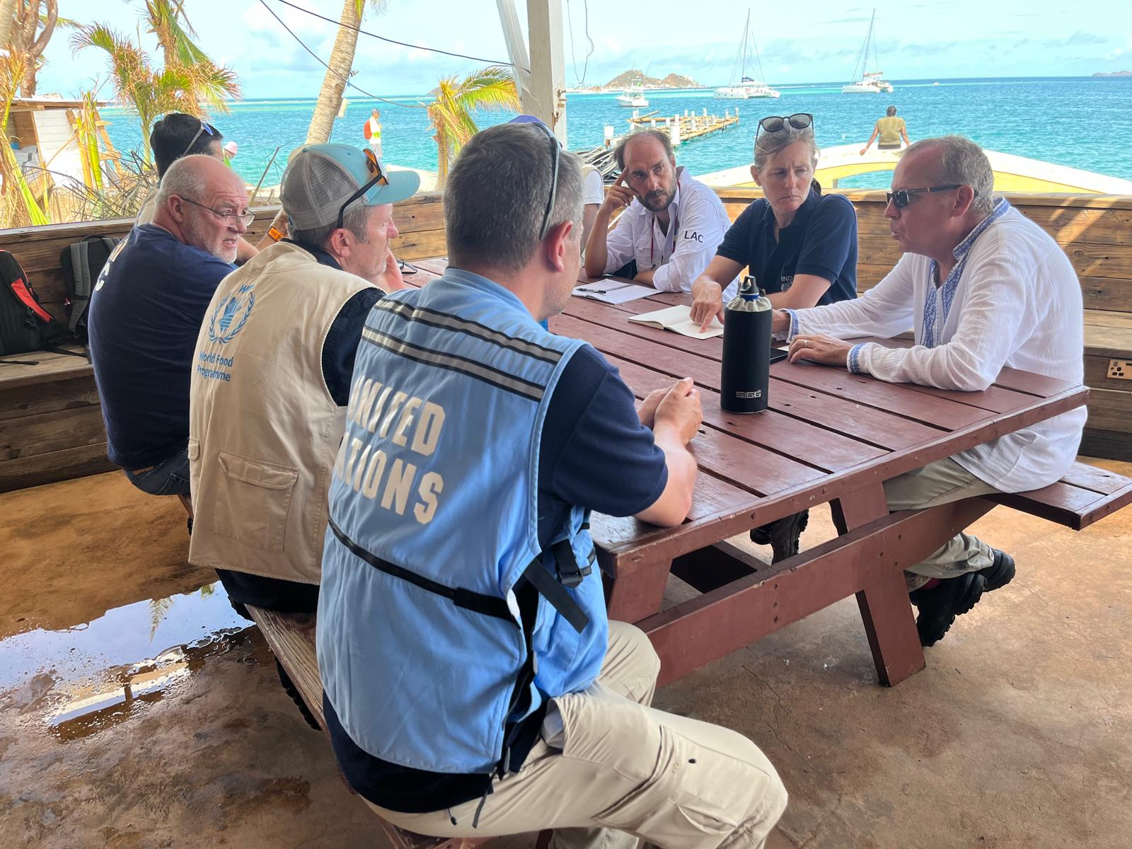 A group of men and women sitting together around a table, engrossed in deep discussion