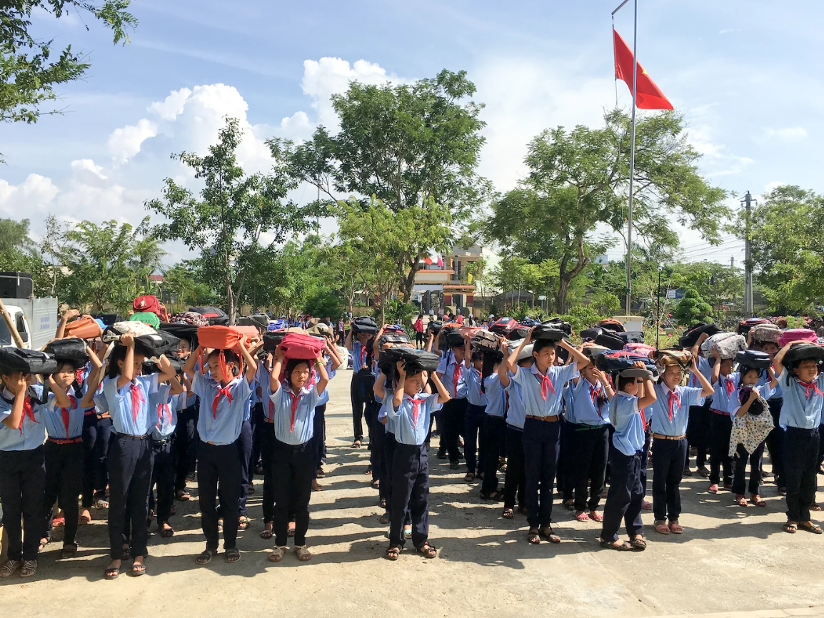 A group of Vietnamese students participating in a disaster drill.