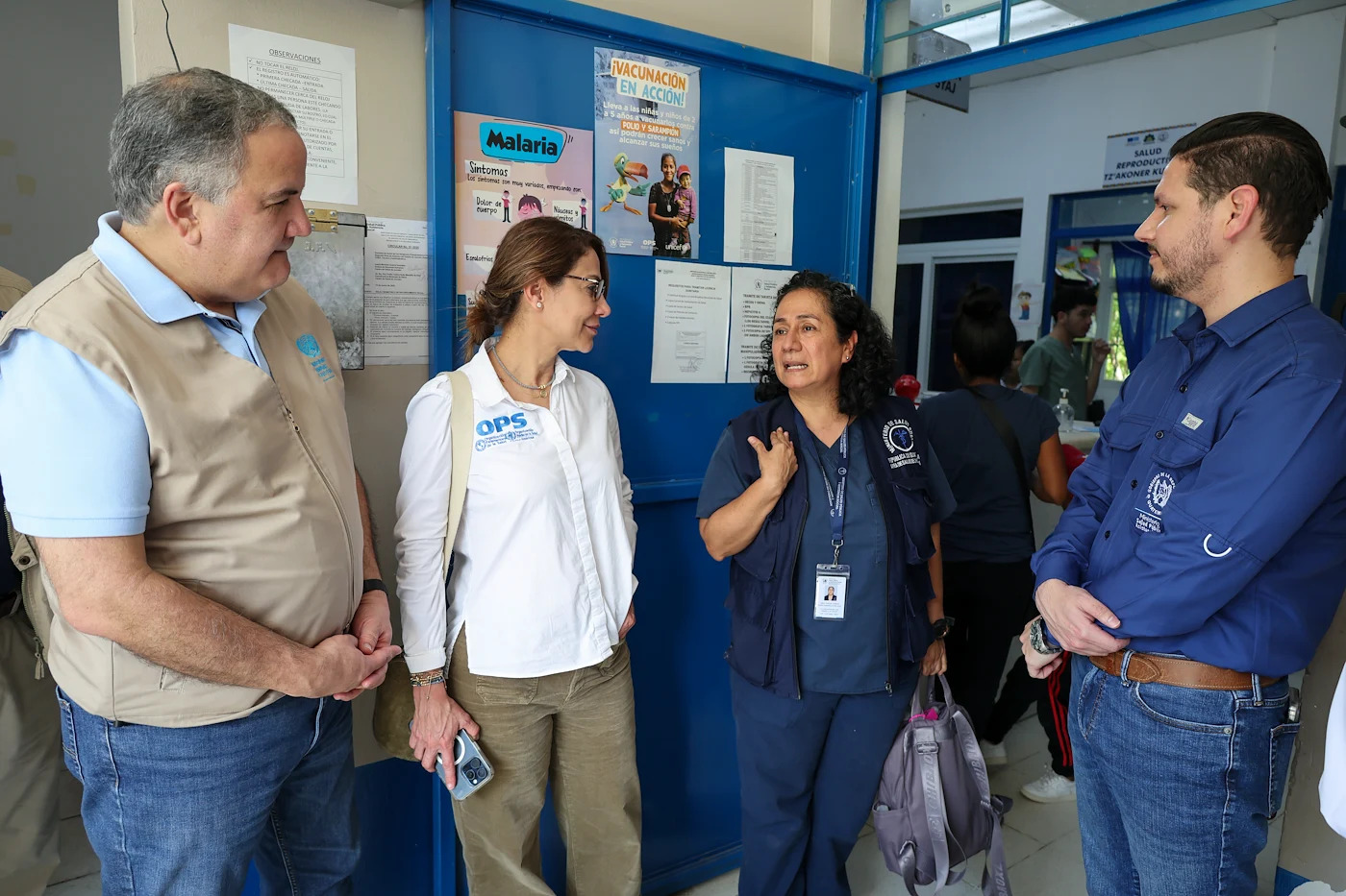 Four high-level UN officials (two women and two men) talk amongst each other.