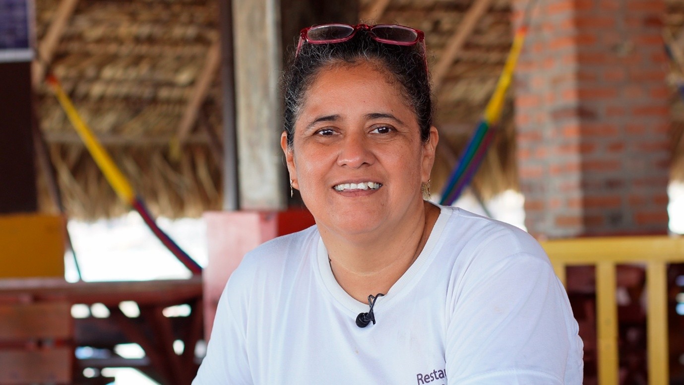 A woman in El Salvador smiles for a photo.