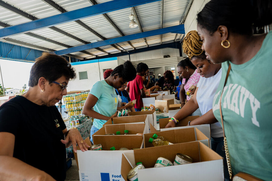 Women humanitarians package supplies to deliver after a disaster in Jamaica.