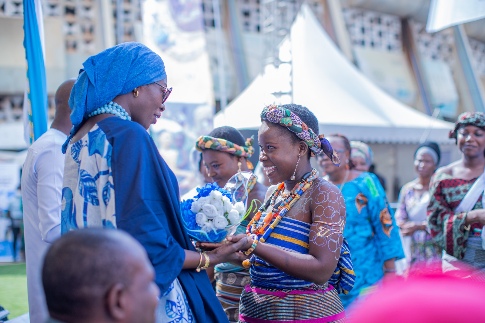 A young Togolese woman speaks to another woman.
