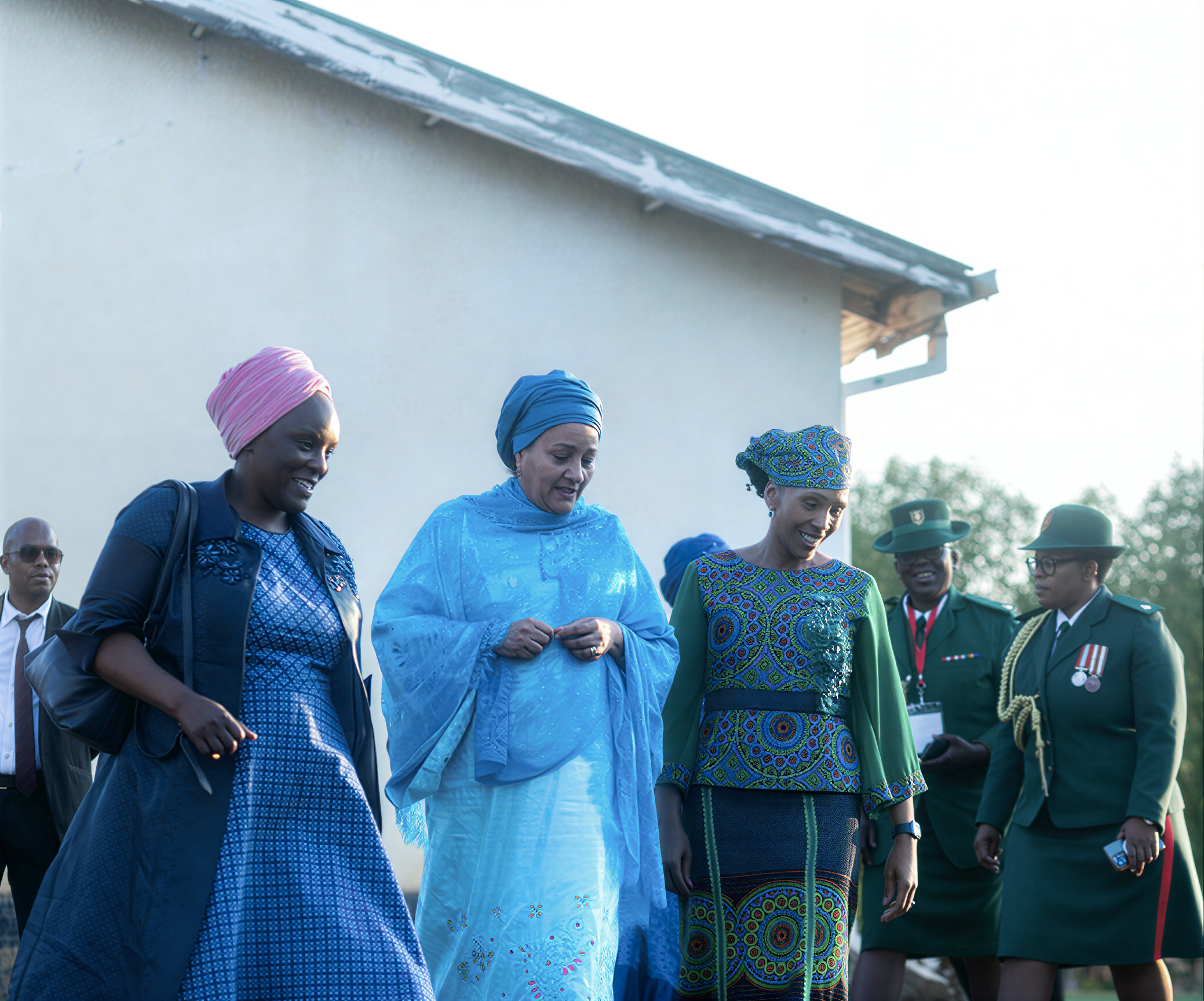 High-level UN officials and national partners in Lesotho surveil a newly-built women's shelter.