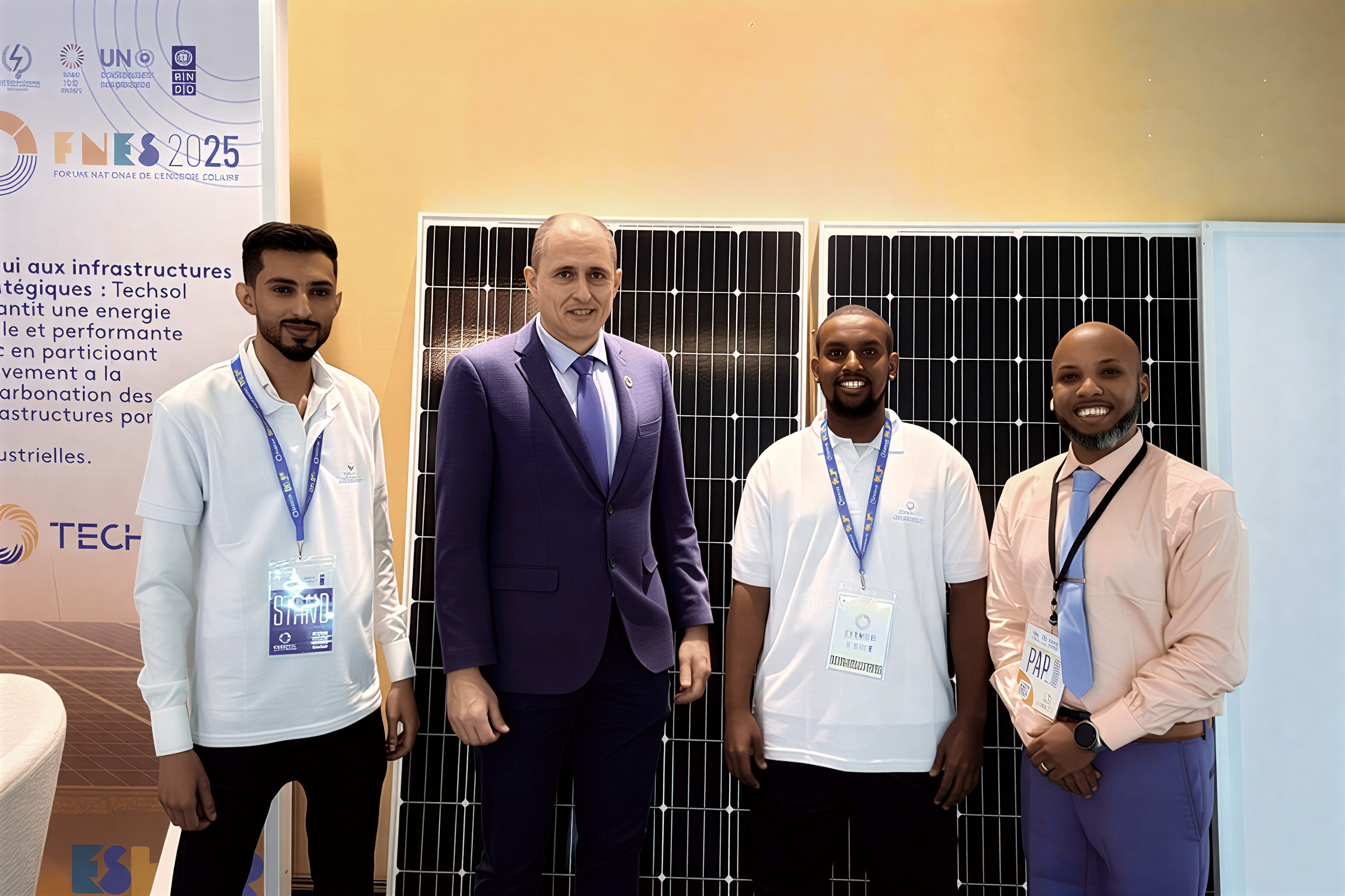A high-level UN official poses for a photo with young solar entrepreneurs during a forum in Djibouti.