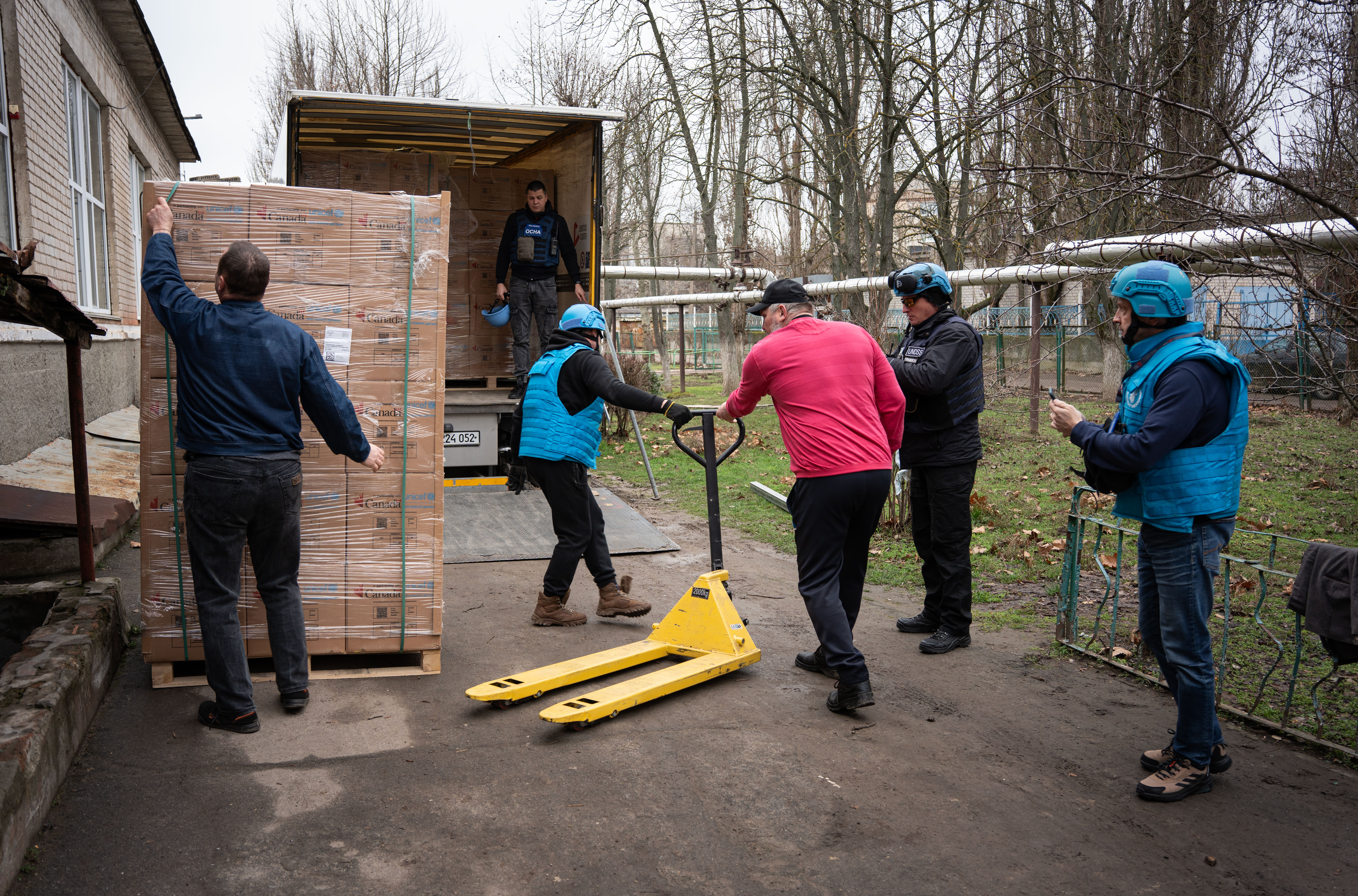 Men load a humanitarian truck with supplies in Ukraine.