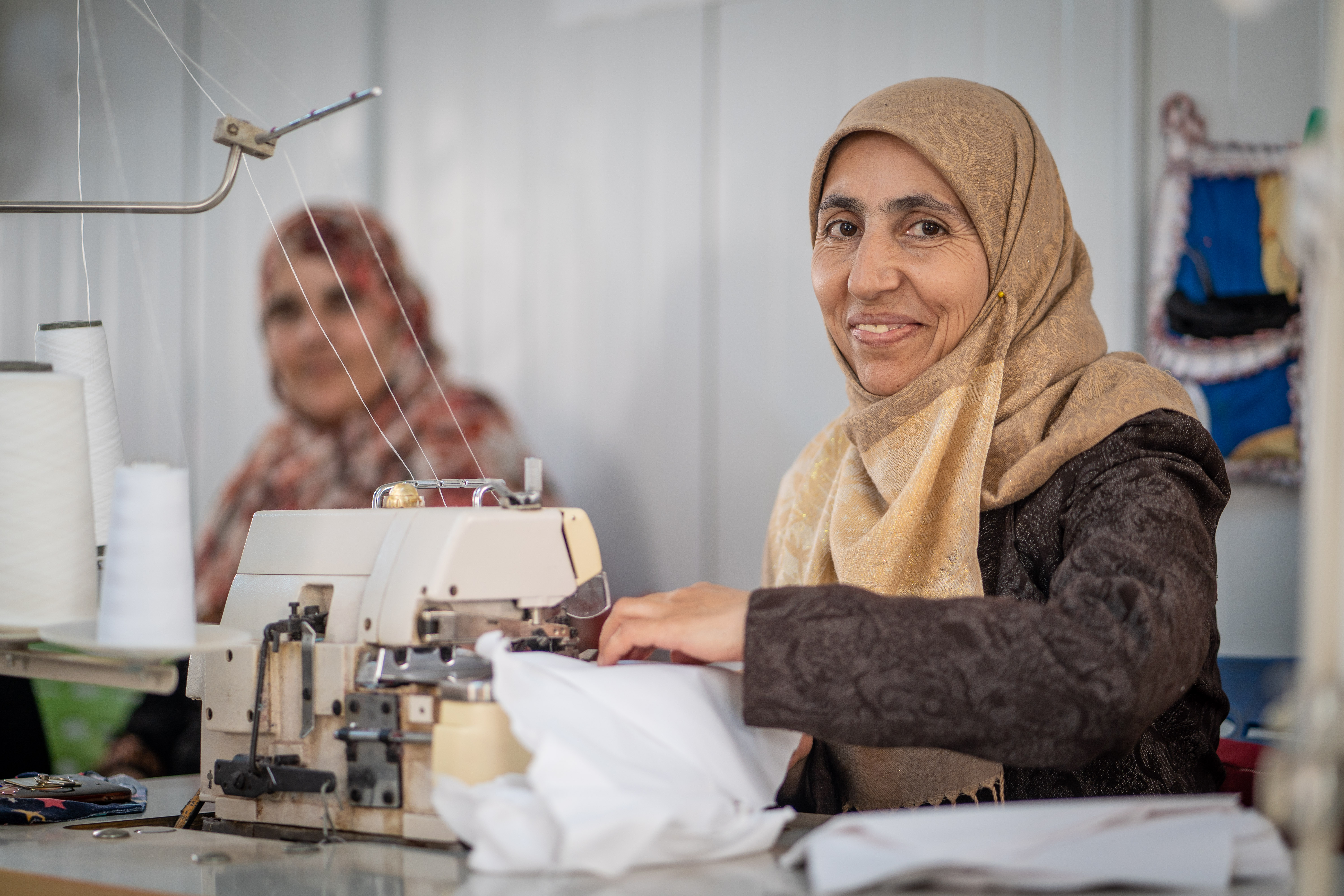 A woman in Jordan uses a sewing machine.