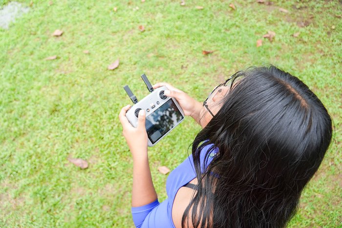 A girl in Costa Rica operates a drone.