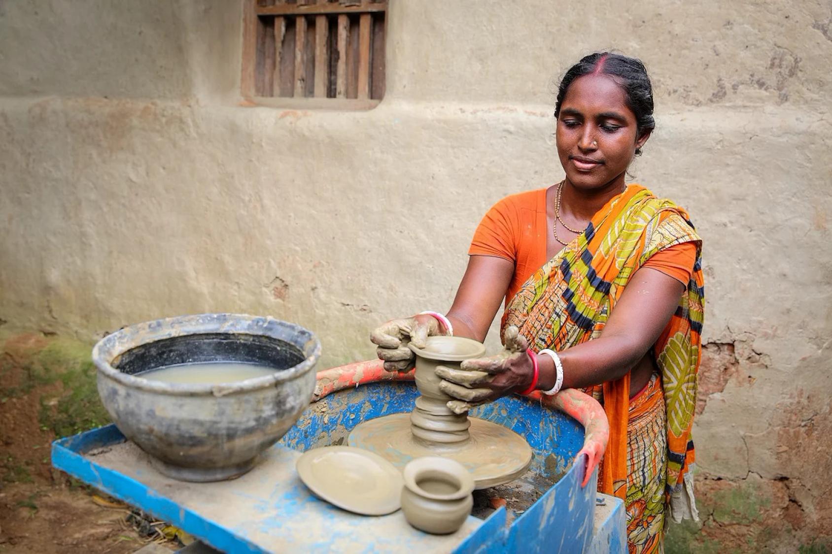 A woman in Bangladesh does pottery.
