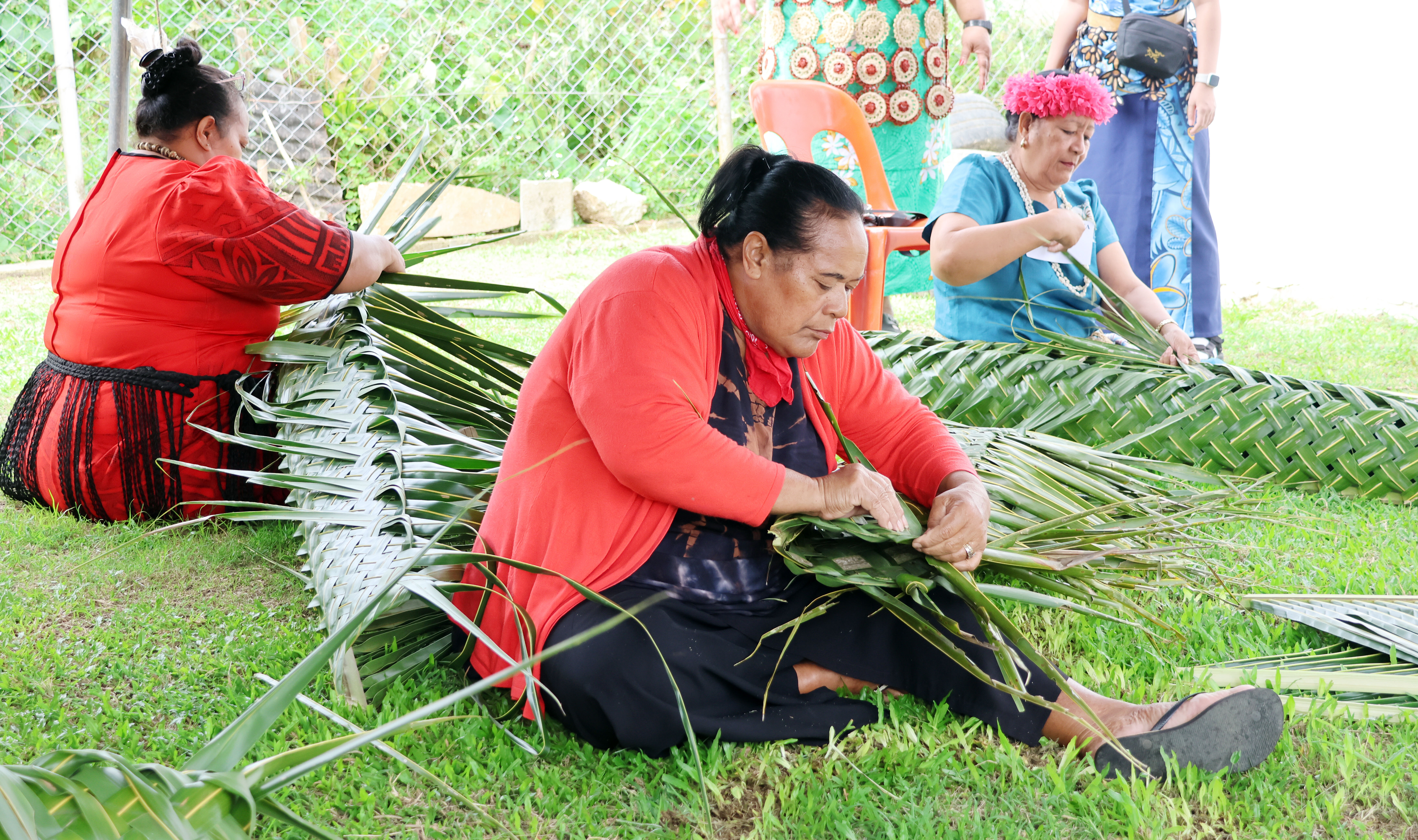 Women in Tonga weave together.