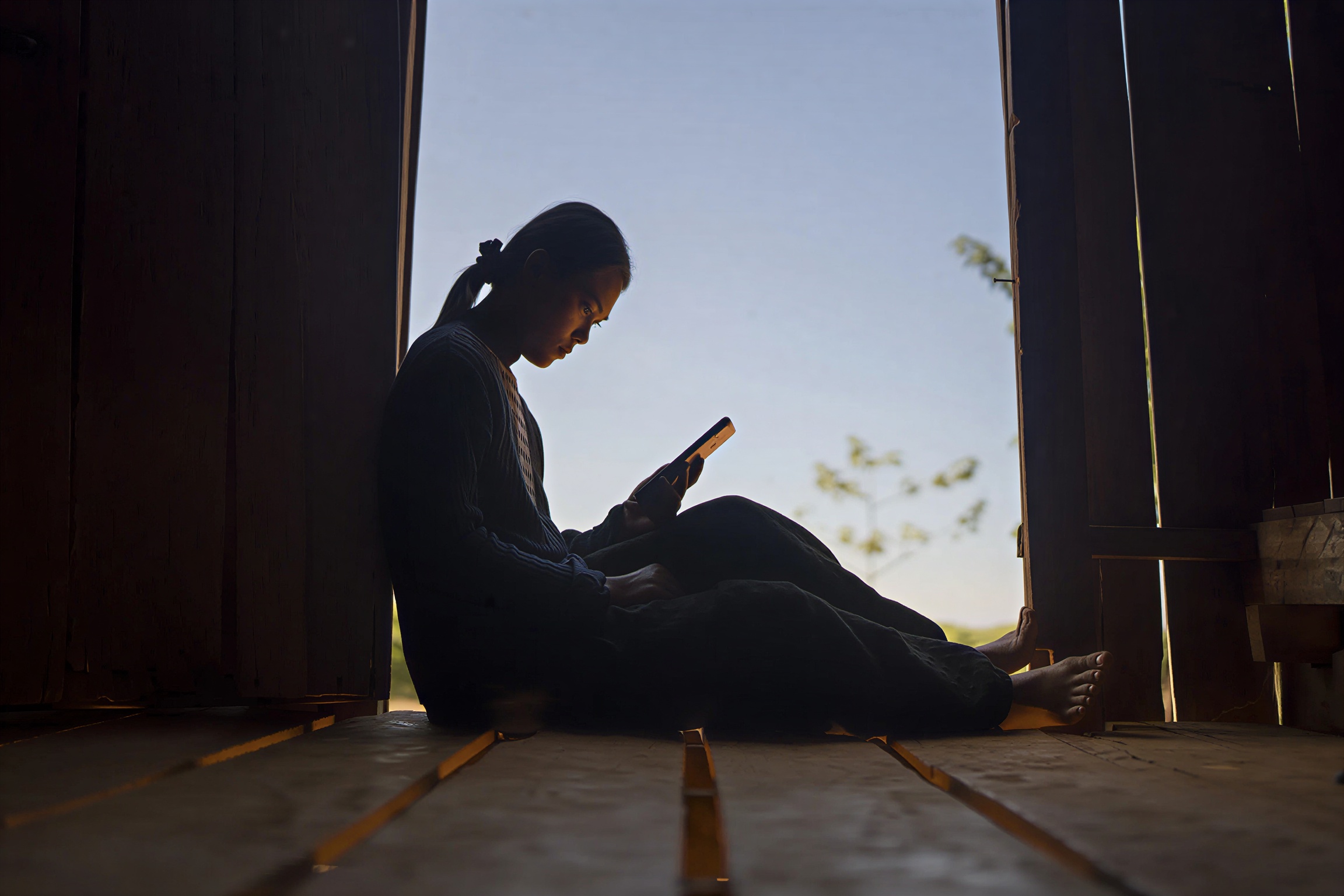 A girl looks at her phone.