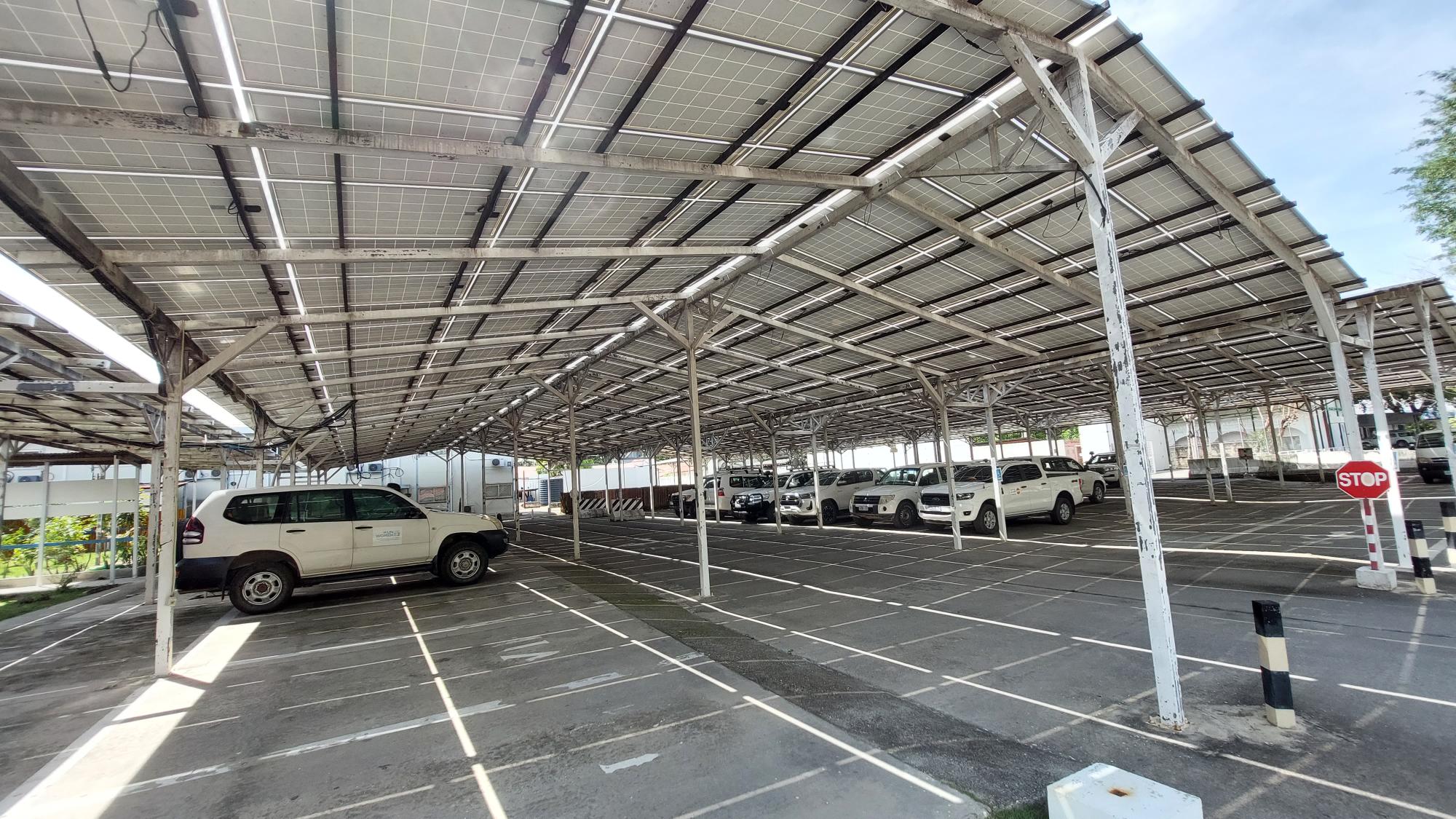 Car parked underneath solar panel structure 