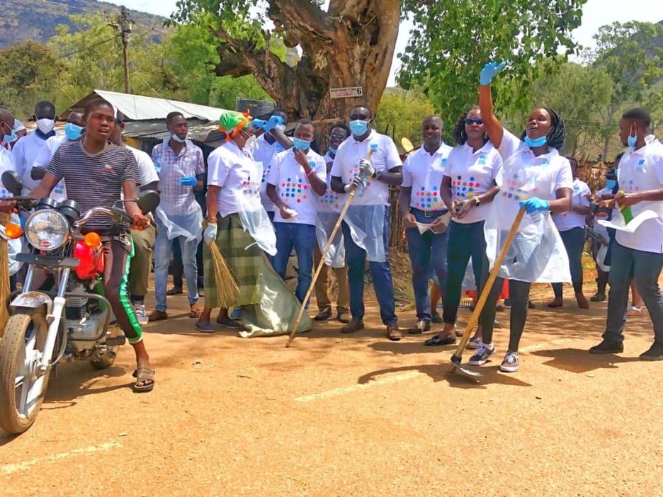 group of people stand on the road with tools for cleaning 