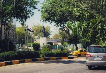 A view of a tropical landscape and roads with cars.