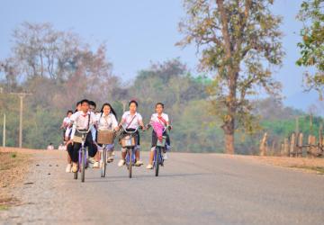 group of children cycle along a road 