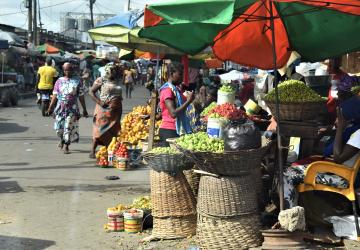 busy market with people selling fruit and vegetables 