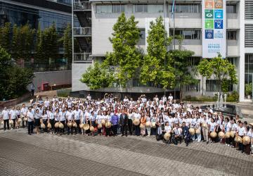 photo from above of large group of people standing outside a building 
