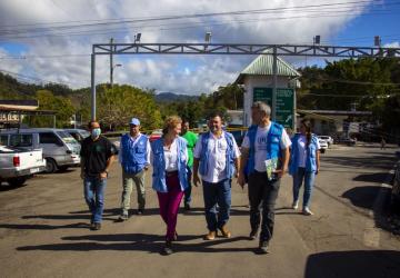 group of people in blue vests walk towards the camera 