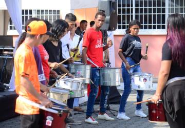 A popular youth group plays drums and music outside.