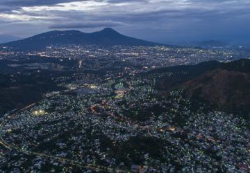 Aerial view of a cityscape in El Salvador during the evening