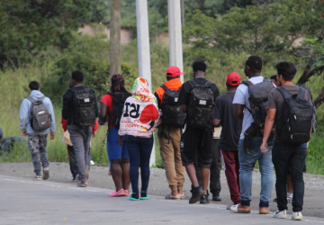 a group of young people walking on the side of the road
