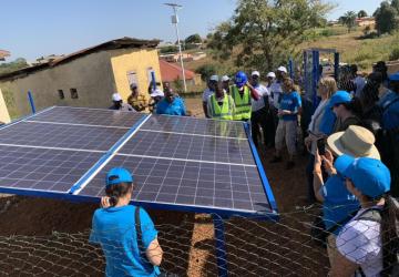 A group of people set up a solar panel