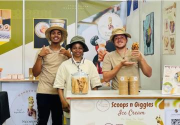 Employees of a local ice-cream store happily pose for a photo.