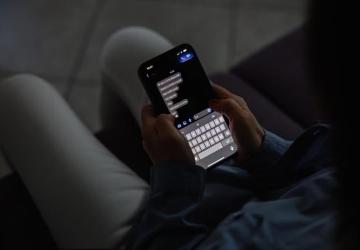 A girl reads messages on her phone.