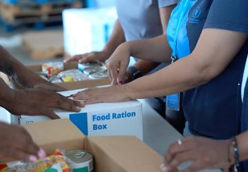 Humanitarians package food ration kits after a hurricane in Jamaica.