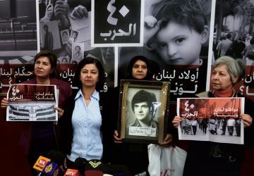 Four women in Lebanon hold photos of their missing relatives.