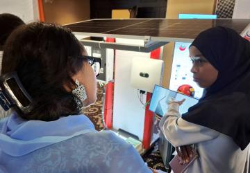 A young Djiboutian solar energy entrepreneur presents her company’s products to participants during a forum.