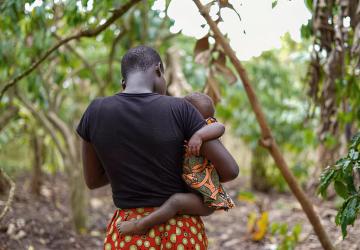 A woman carries her child.
