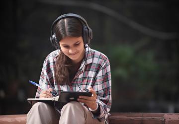A girl watches a video on her phone.