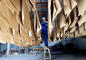 A man in Afghanistan works in a paper factory.