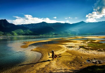 A wide shot of a man walking amid Viet Nam's stunning natural landscape.
