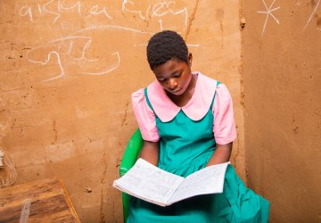 A girl in Malawi reads a book.