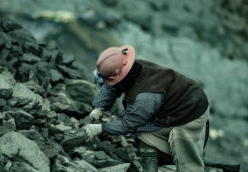 A miner harvesting coal.