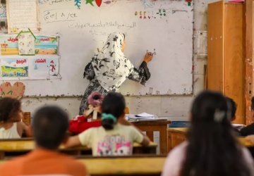 Students in a classroom listen to a teacher in Egypt.
