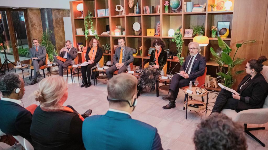 A group of people seated in a room discussions the North Macedonia Development Strategy