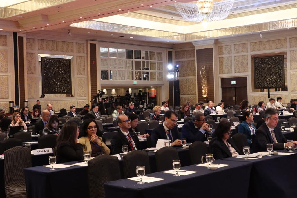  A large group of people gathered in a convention hall.