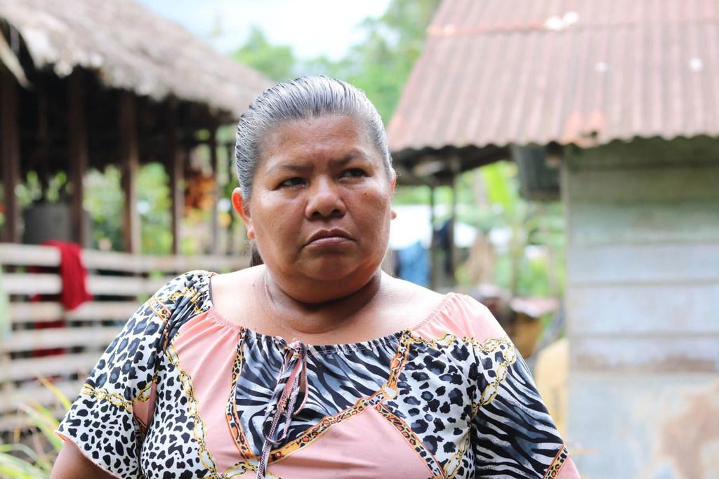 A woman looking away from the camera with a very stern face 