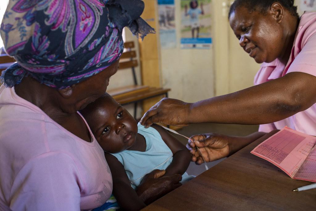 A baby in Zimbabwe receives a vaccine as she sits in her grandmother's arms.