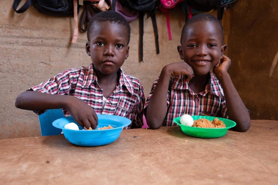 Two little boys eating.