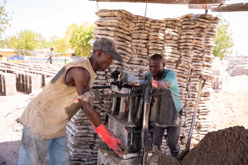 Two construction workers working.