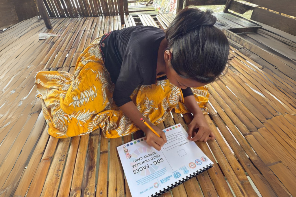 A woman in the Philippines fills in a form.