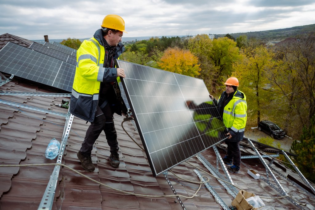 Solar panels being installed on a roof in Moldova.