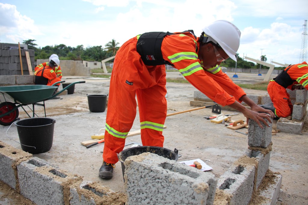 Workers construct a building in Cuba.