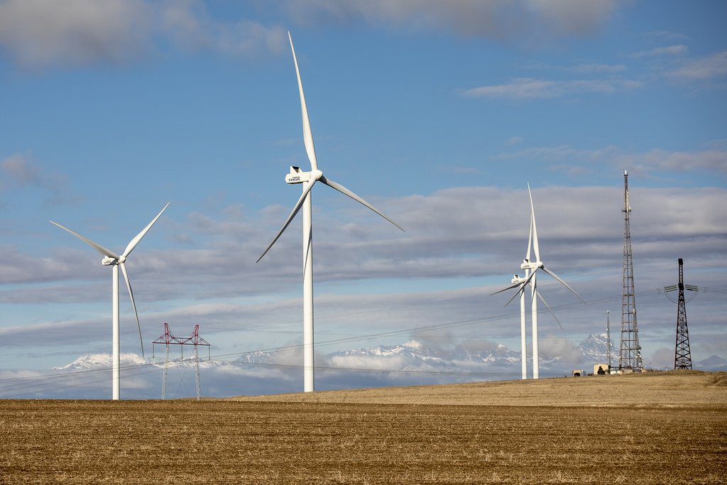 wind-farm against cloudy blue sky 