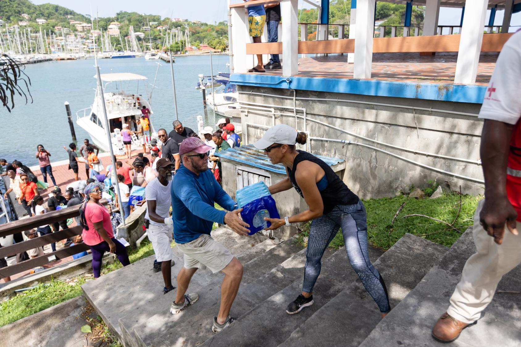 A group of people handing each other supplies