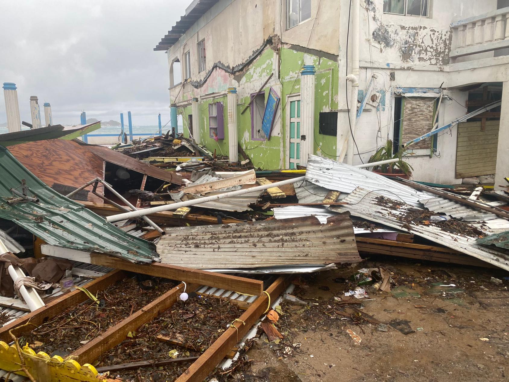 A completely devastated area, with houses collapsed and damaged